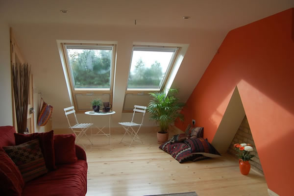 Bright loft room with wood flooring